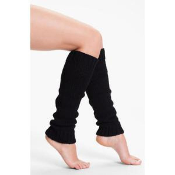 Black leg warmers worn by a person on a white background