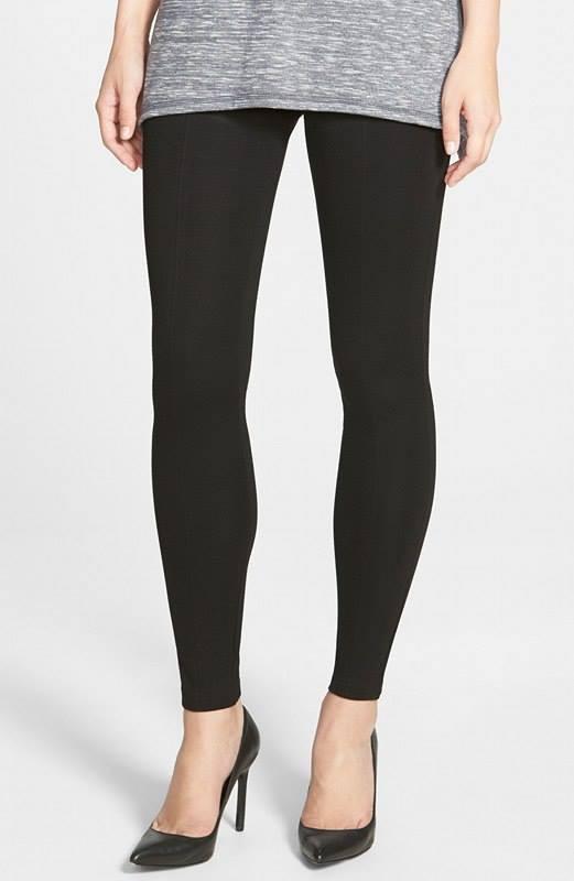 Person wearing black leggings on a white background