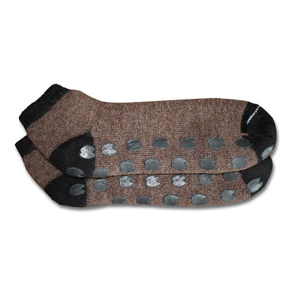 Pair of brown socks with black toes and heels on a white background. Stay cozy with AlpacaTrax Gripper Slipper Socks – ultra-warm, non-slip alpaca wool socks for men & women. Breathable, odor-free, durable, and machine washable. Perfect house slipper alternative.