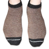 Brown socks with black cuffs and toes on a white background. Stay cozy with AlpacaTrax Gripper Slipper Socks – ultra-warm, non-slip alpaca wool socks for men & women. Breathable, odor-free, durable, and machine washable. Perfect house slipper alternative.