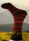 Knitted sock with pattern against a blurred natural background