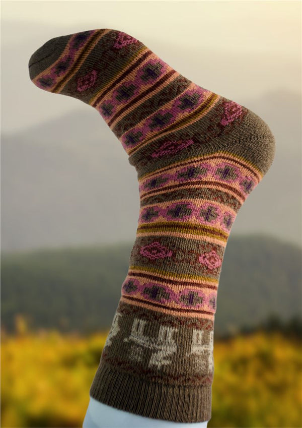 Knitted sock with a pattern against a blurred natural background