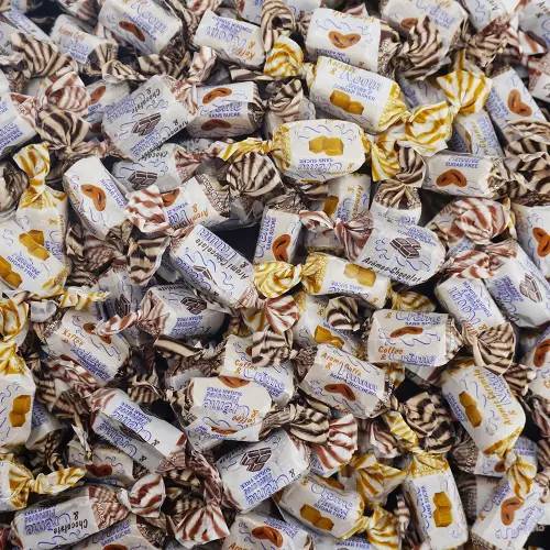 Individually wrapped sugar-free cream toffee pieces in three flavors laid out on a surface — Andy Anand SoCal bakery