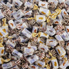 Individually wrapped sugar-free cream toffee pieces in three flavors laid out on a surface — Andy Anand SoCal bakery