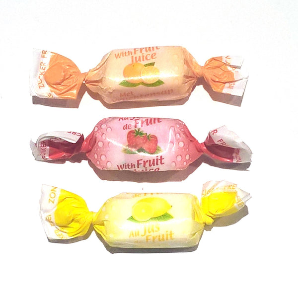 Three wrapped candies with fruit flavors on a white background. Enjoy Andy Anand’s 70-piece Sugar-Free Fruit Toffees. Naturally sweetened, vegan, and gluten-free, these artisan European toffees come in Strawberry, Orange, and Lemon. The perfect guilt-free gift for diabetics and health-conscious snackers!