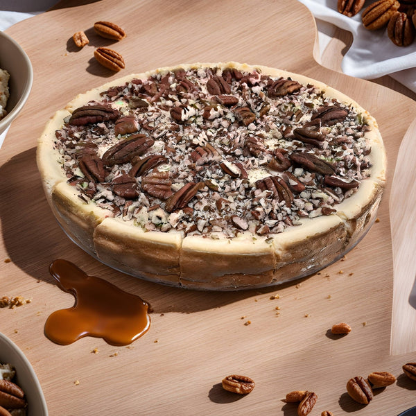 Side view of Andy Anand sugar-free caramel pecan cheesecake showing dense 2.8-lb cream cheese filling on certified gluten-free crust