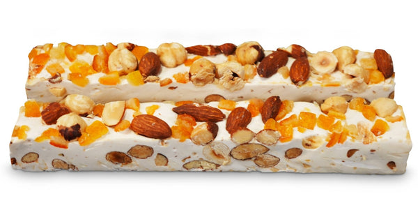 Two bars of nougat with nuts on a white background