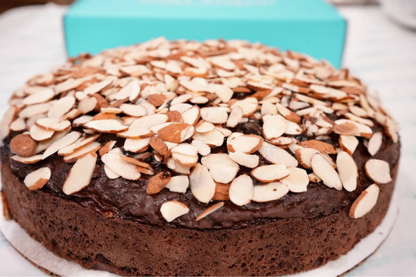 Chocolate cake with sliced almonds on a white plate. Indulge in Andy Anand’s 2.5 lb Sugar-Free Chocolate Almond Cake. Naturally sweetened with Stevia and Monk Fruit, this 9" artisan cake is made with real California cream. The perfect diabetic-friendly gift for any celebration!