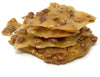 Stack of peanut brittle on a white background