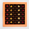 Assorted chocolates in a decorative wooden box on a light gray background