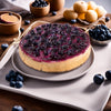 Whole Andy Anand sugar-free blueberry cheesecake showing dense NY-style cream cheese filling topped with fresh blueberries