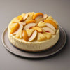 Whole sugar-free tropical fruit cheesecake with vibrant real fruit topping — mango, pineapple, and exotic fruits on a cream cheese base