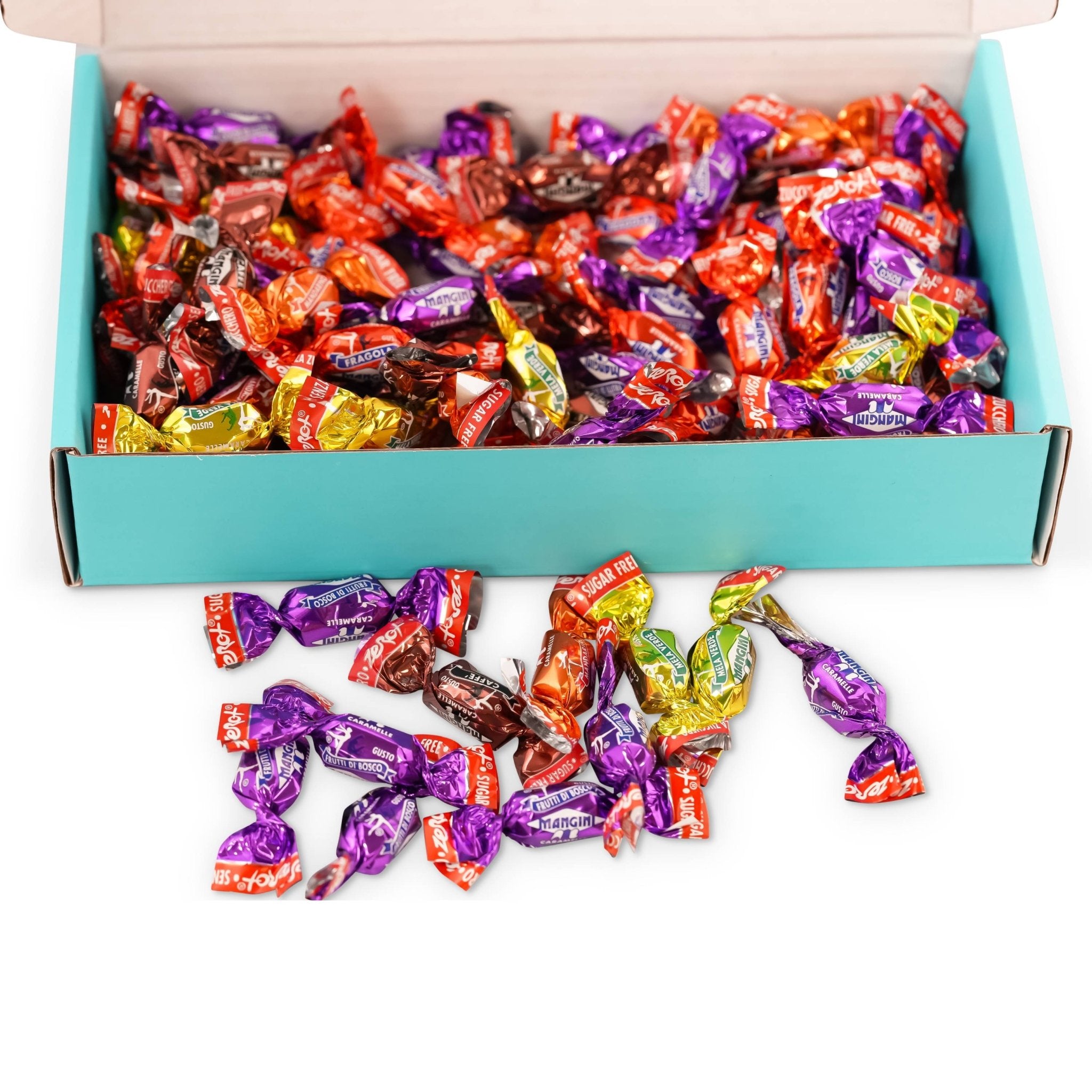 Box of colorful wrapped candies with some spilling out onto a white surface.
