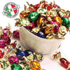 Colorful wrapped candies in a white bowl with 'Made in Italy' logo.