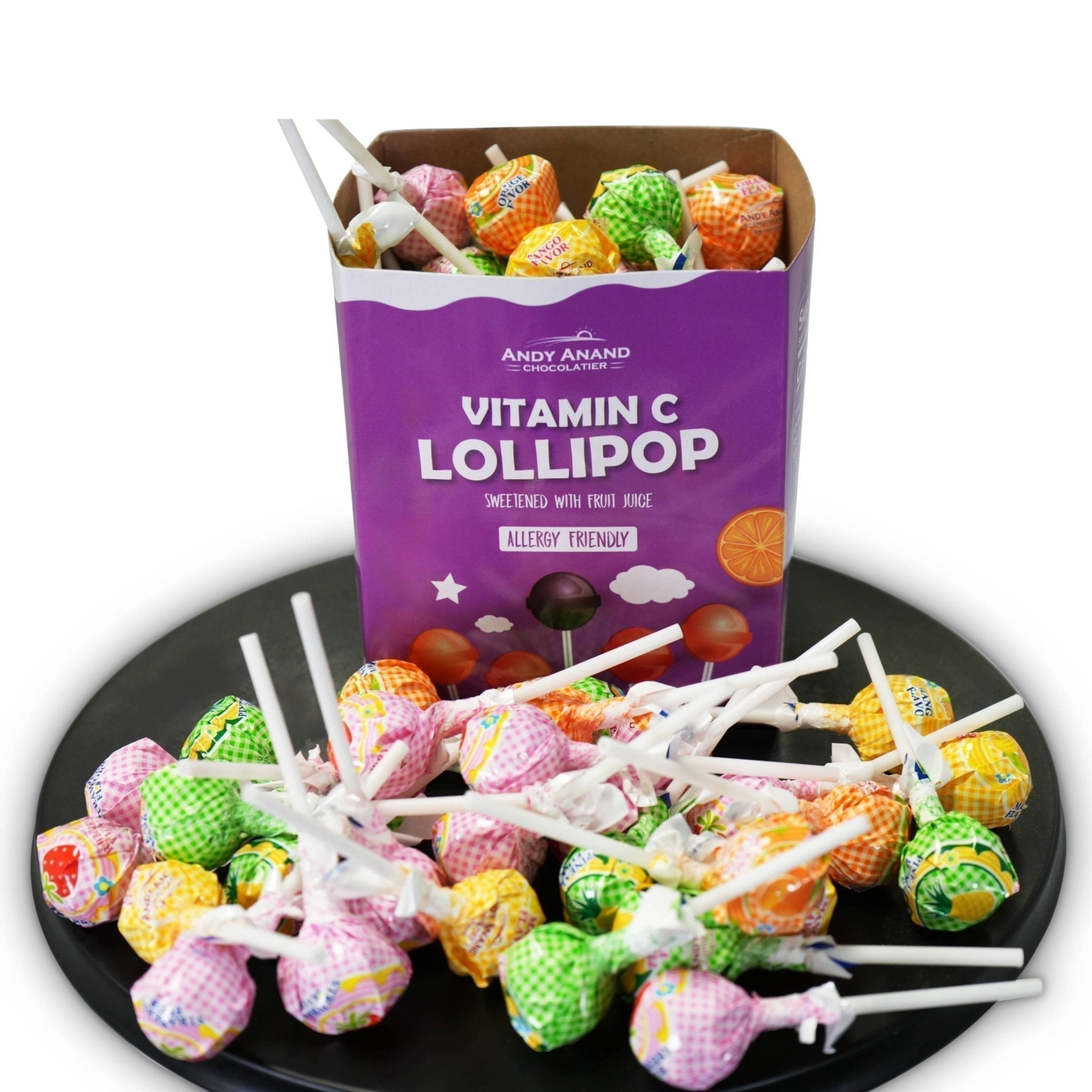 Colorful lollipops on sticks with a box labeled 'Vitamin C Lollipop' by Andy Anand Chocolatier.