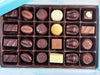 Assorted chocolates in a box on a light blue background