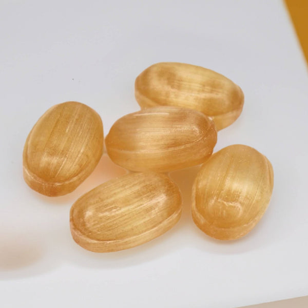 Close-up of Andy Anand sugar free ginger turmeric hard candy showing texture and colour