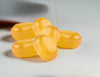 Yellow jelly beans on a white surface with a blurred background