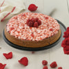 Chocolate cake with raspberry frosting on a white surface