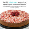 Chocolate cake with raspberry toppings on a black plate, with promotional text about freshness and ingredients.