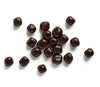 Dark chocolate buttons scattered on a white background
