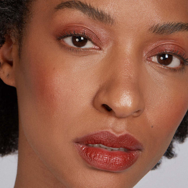Close-up of a woman's face with a neutral background