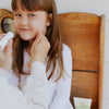 Close-up of Earth Mama SPF 40 sunscreen stick showing EWG Rated 1 and Leaping Bunny certified labels