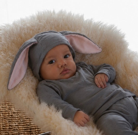 Baby wearing a grey bunny costume with lop ears
