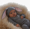 Baby wearing a grey bunny costume with lop ears