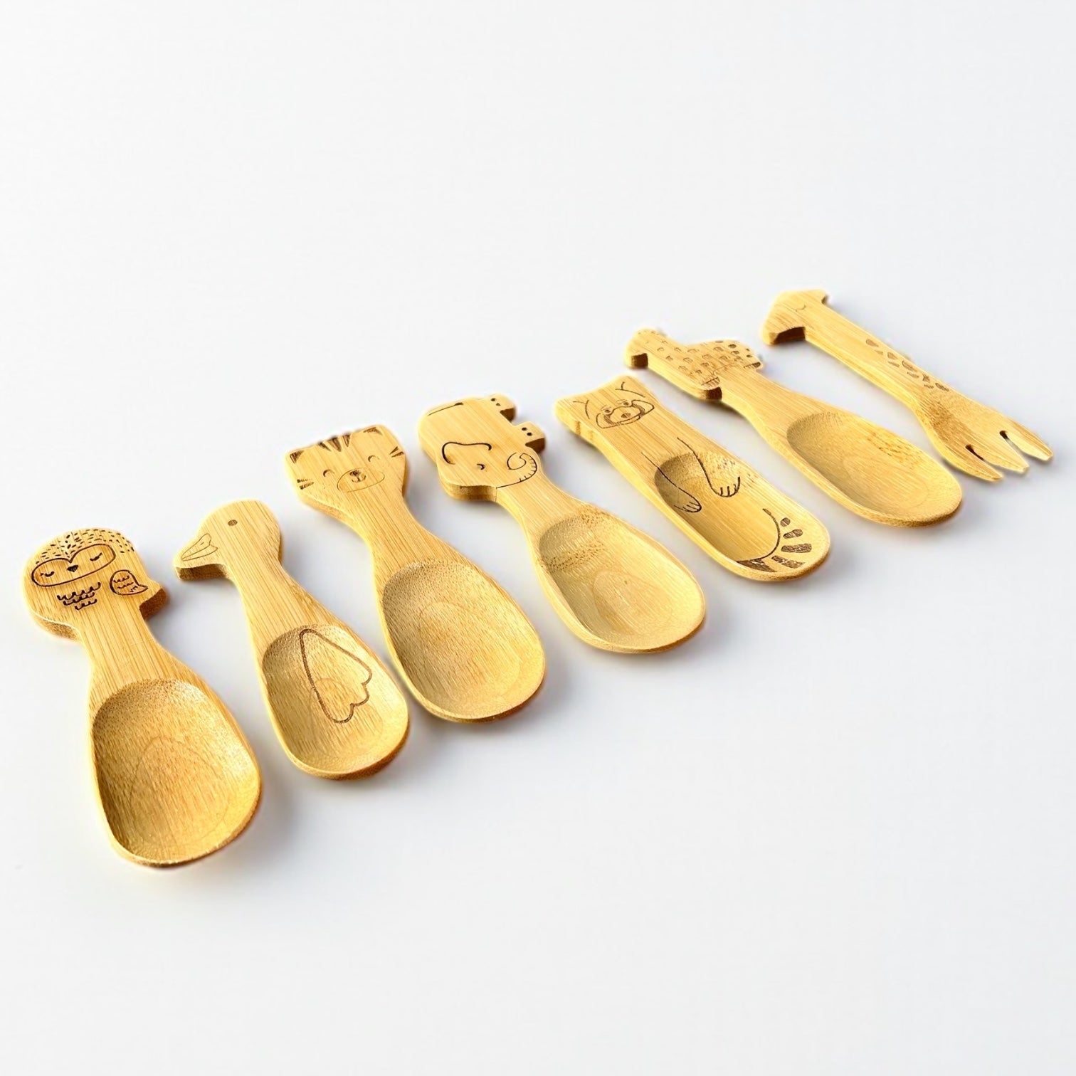Close-up of a bamboo kids spoon showing the hand-carved animal shape