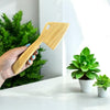 Close-up of the Bamboo Dough Scraper's curved edge and wood grain