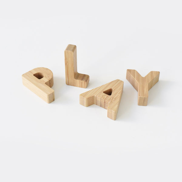 Close-up of bamboo alphabet letters showing size and thickness, ideal for small hands
