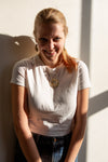 Model wearing fair trade beaded banana fruit earrings, lightweight and nickel-free, 2.5 inches long