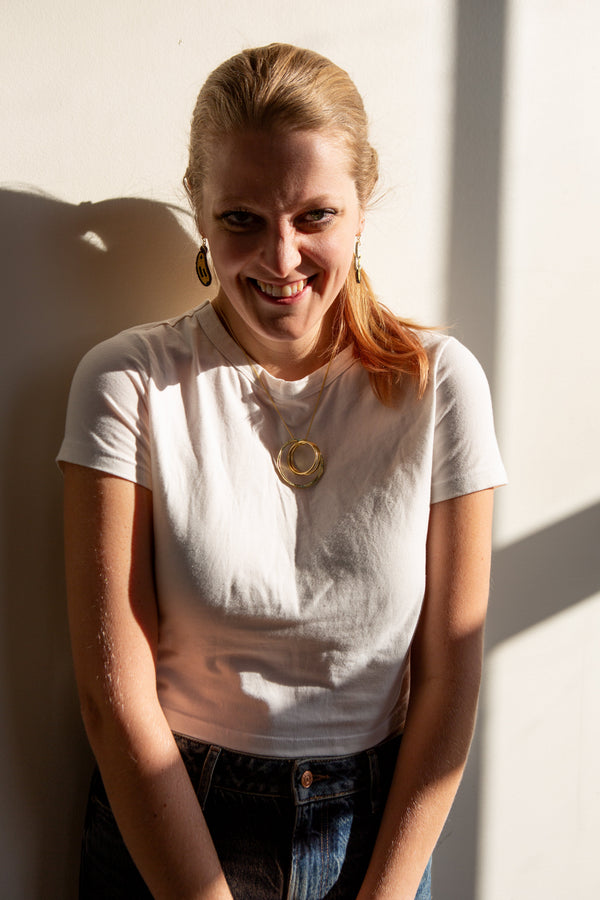 Model wearing fair trade beaded banana fruit earrings, lightweight and nickel-free, 2.5 inches long