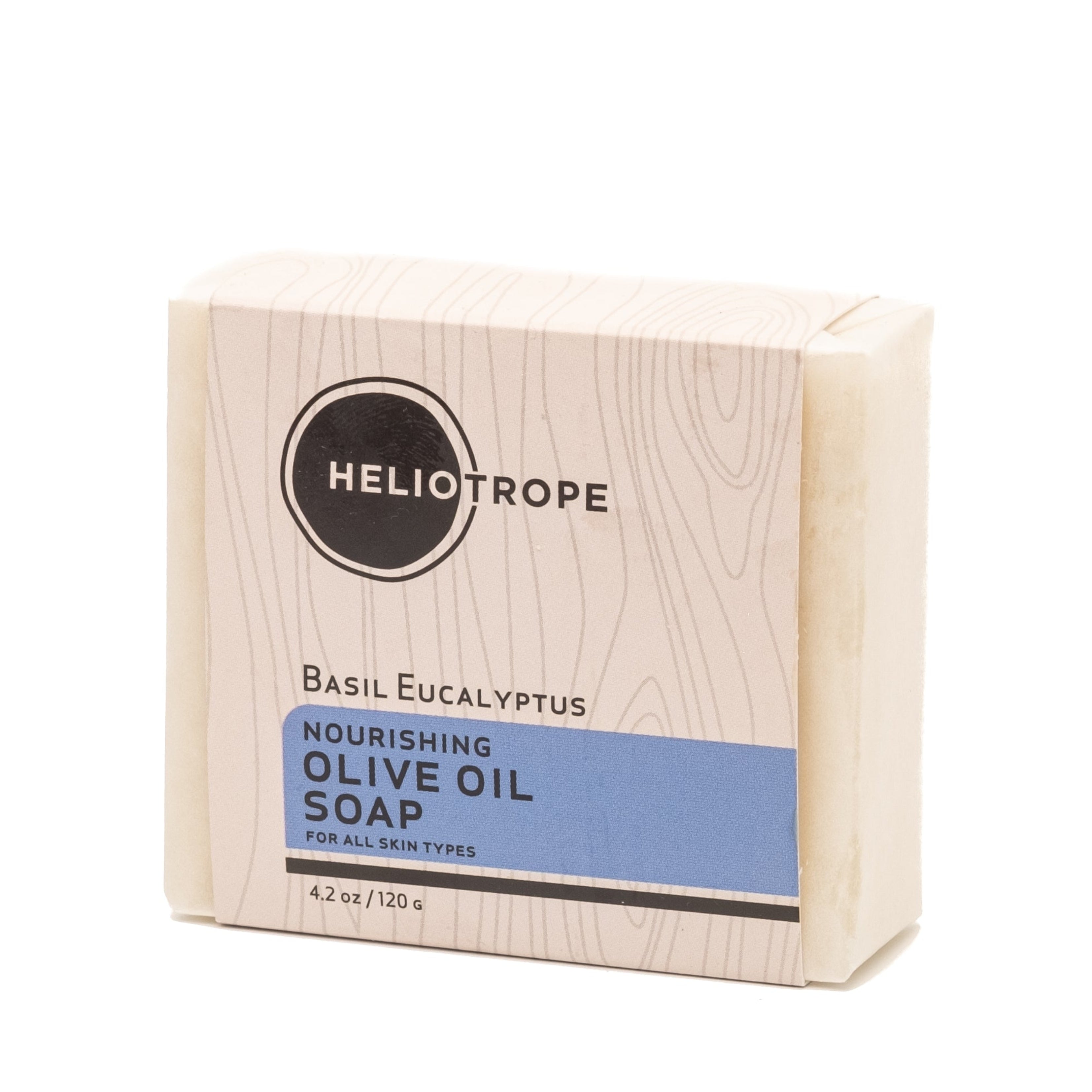 Bar of soap in a wooden box with Heliotrope branding on a white background