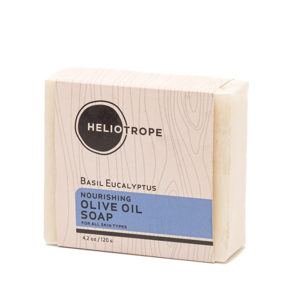 Bar of soap in a wooden box with Heliotrope branding on a white background