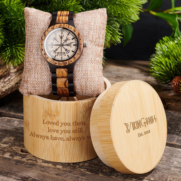 Wooden watch with engraved message in a wooden box on a rustic background