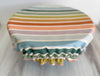 Reusable cotton bowl cover with colourful beach chair stripes covering a bowl – eco-friendly alternative to cling wrap