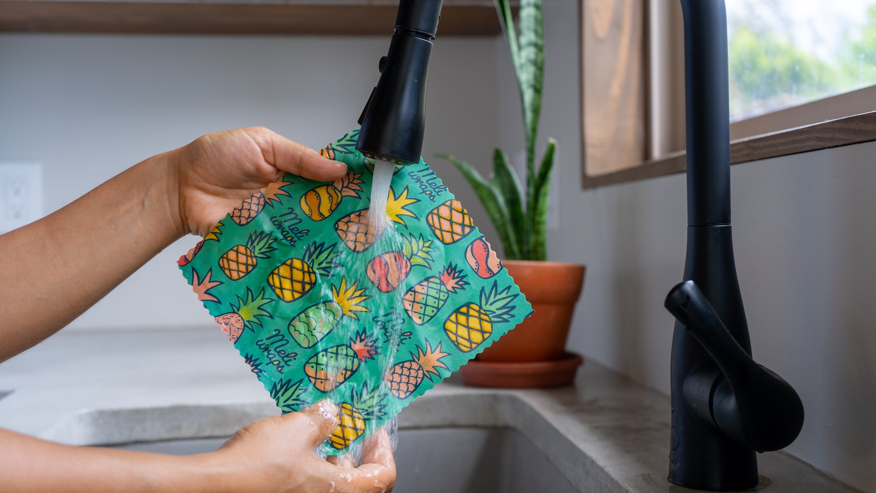 Washing a Meli Wraps beeswax wrap with Pineapple Print in blue