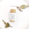 Butter Me Up Organics belly balm on a white plate with green leaves