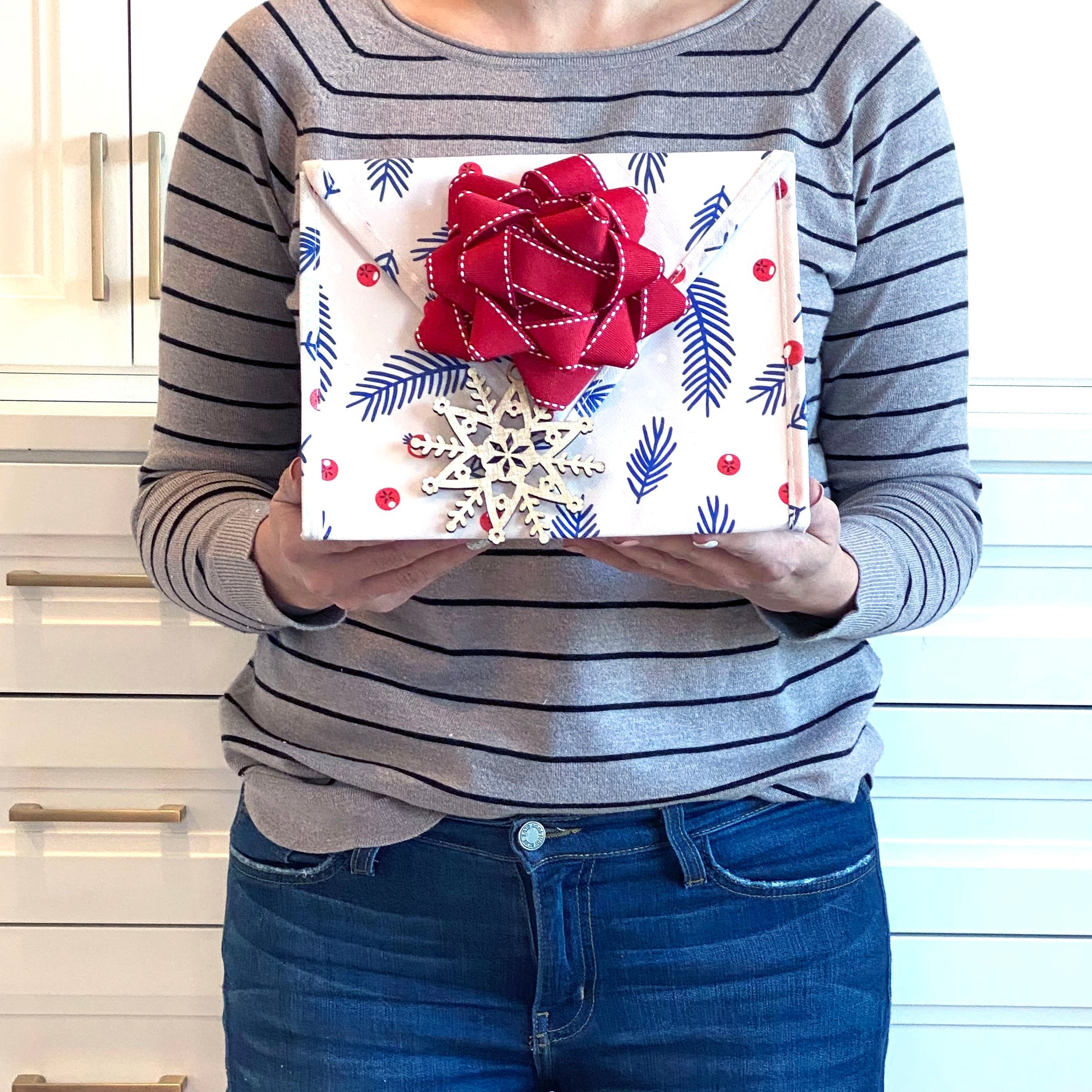 EverEnvelope small eco-friendly gift bag styled with gift contents and accessories on a flat lay background