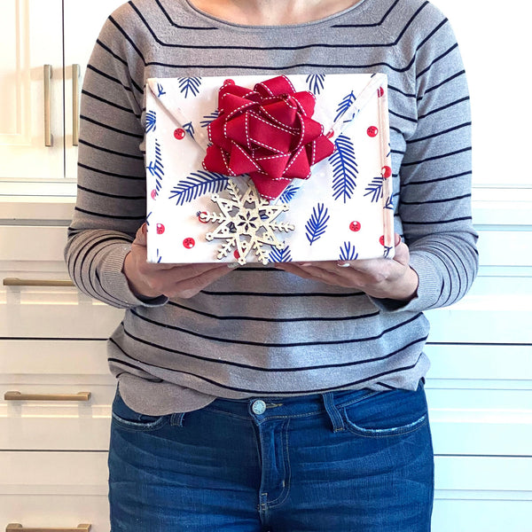 EverEnvelope small eco-friendly gift bag styled with gift contents and accessories on a flat lay background