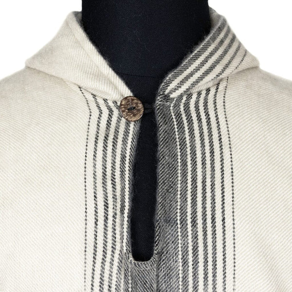Close-up of black and grey gradient diamond weave pattern on ivory alpaca poncho