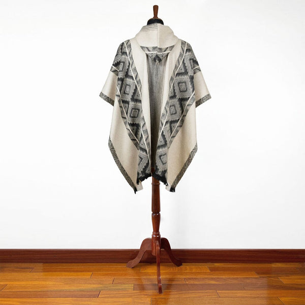 Side view of black grey diamonds alpaca poncho draped over shoulders, handcrafted in Ecuador