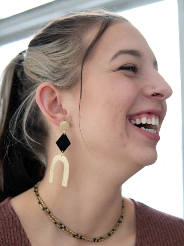 Side view of bold slate and gold arch earrings showing lightweight upcycled brass construction