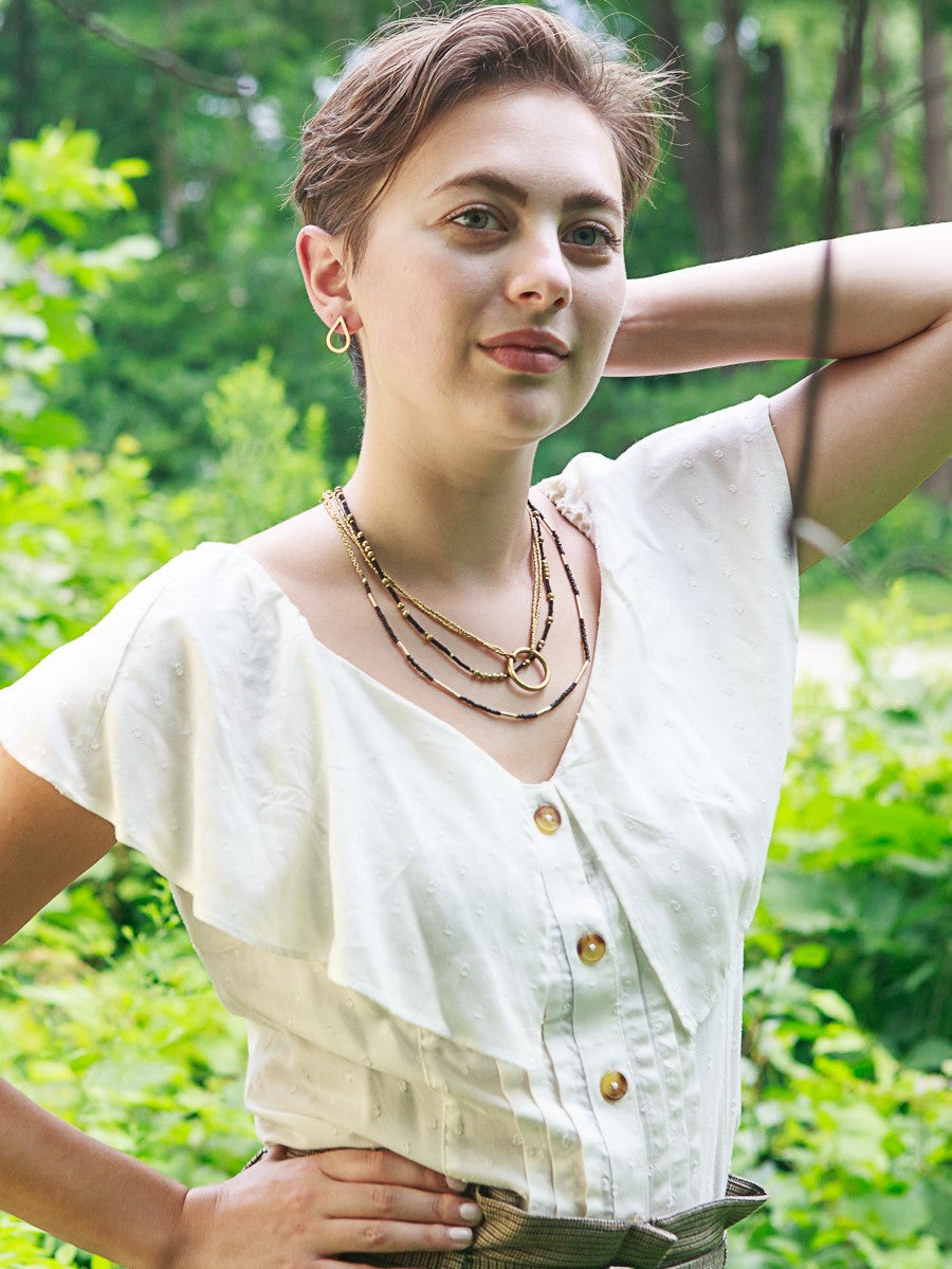 Close-up of black seed beads and brass pipe Morse Code Necklace handcrafted by women artisans in India