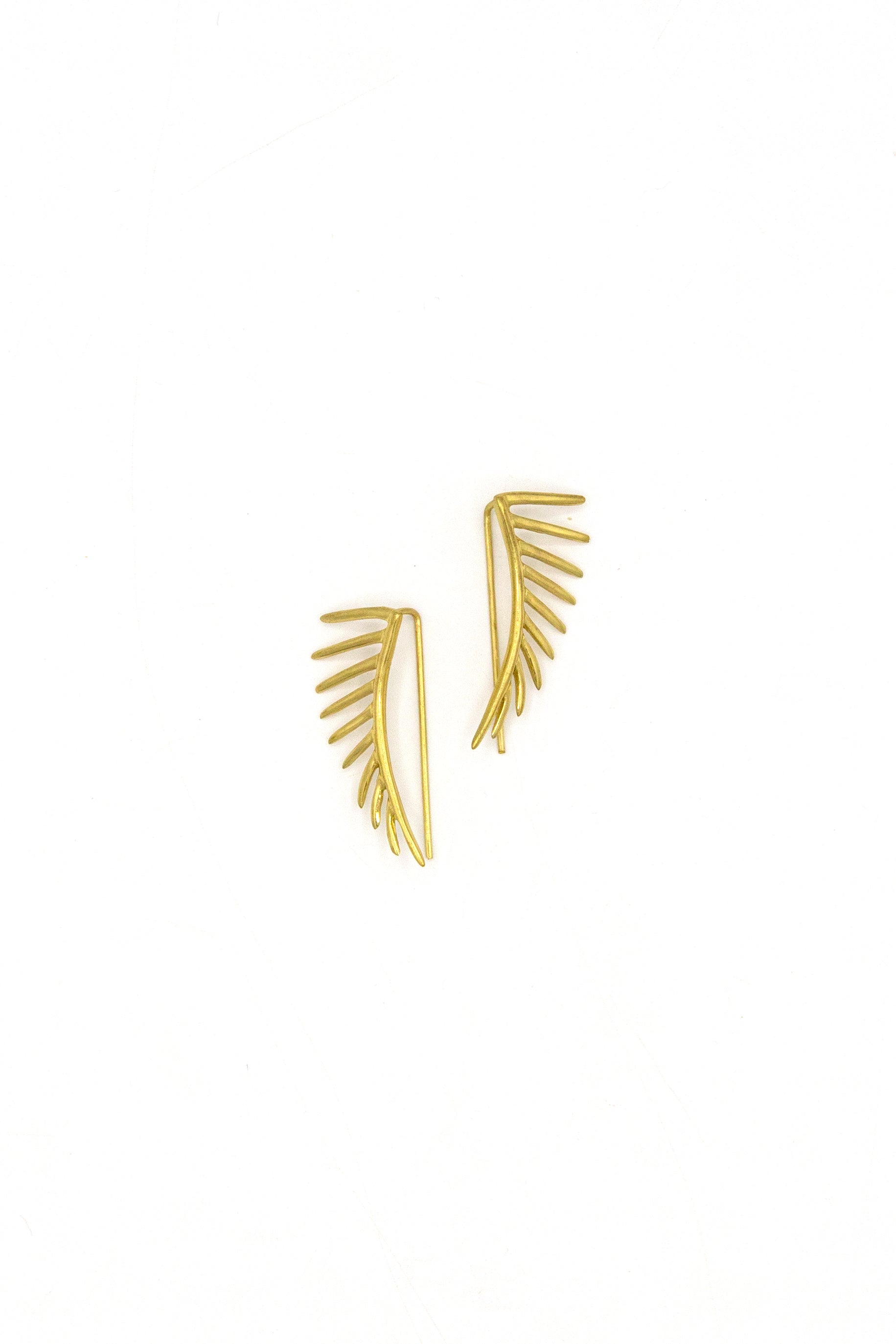 Detail shot of Black Swan Wing earring design showing e-coated recycled brass finish