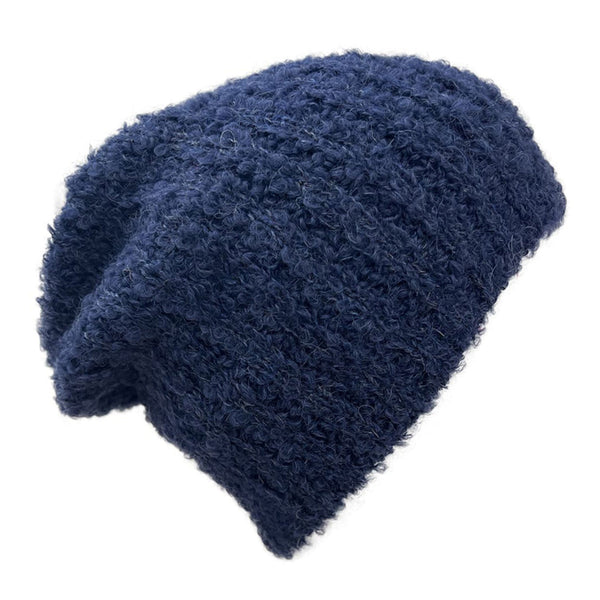 Blue knitted beanie hat on a white background