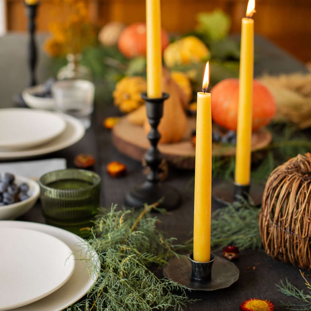 Bluecorn Candles beeswax taper candles styled on a fall dinner table with warm candlelight