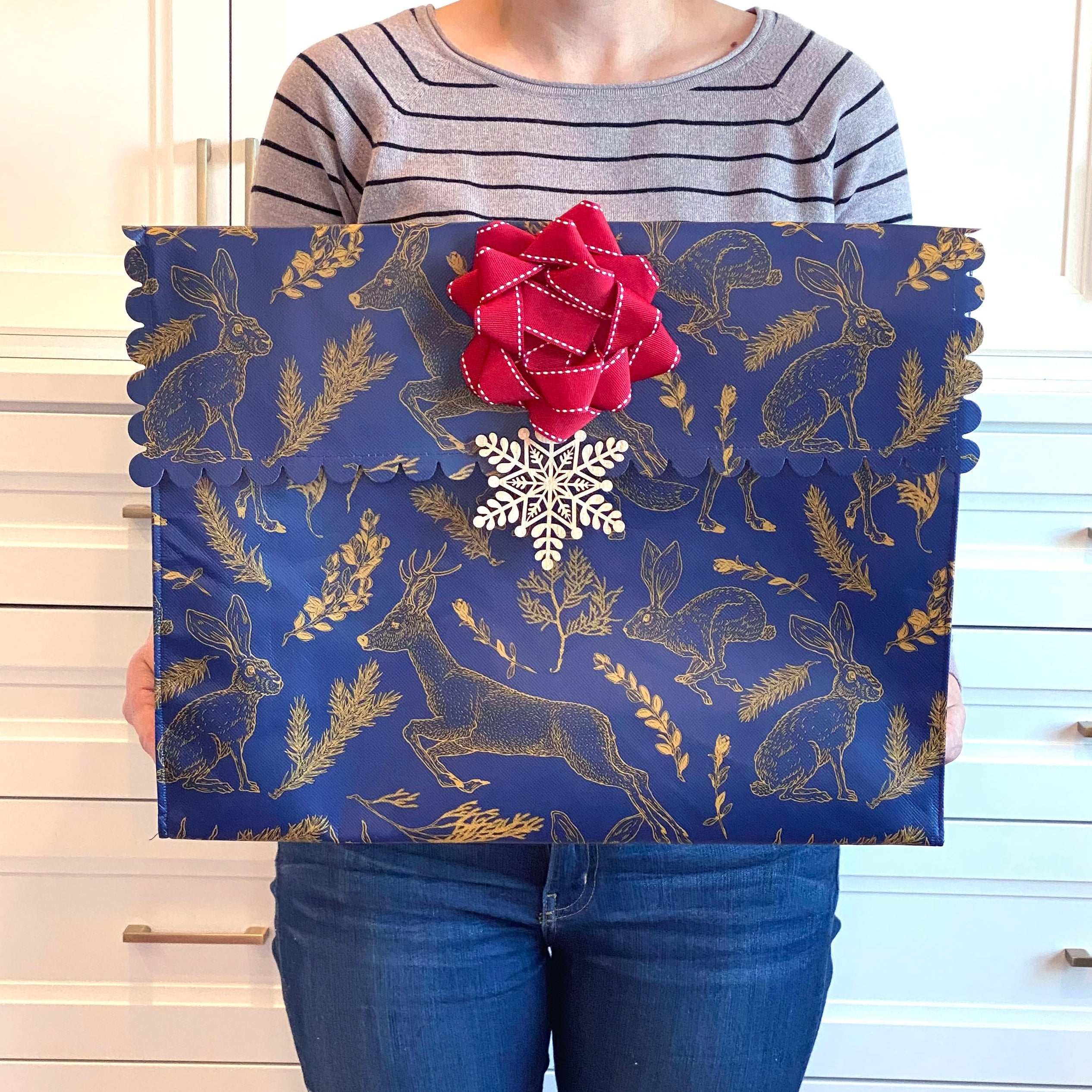 Flat lay of large navy reusable gift bag with illustrated forest animals pattern